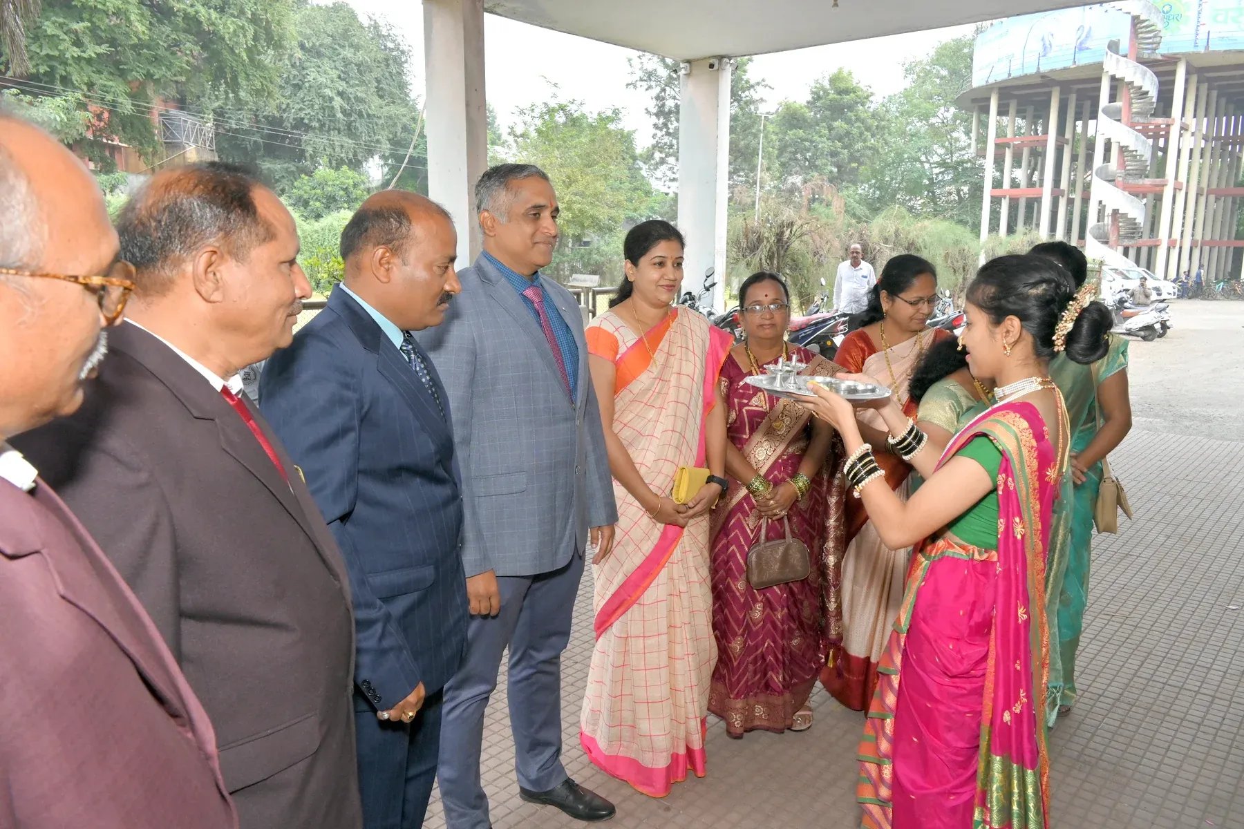 Guests being welcomed with a traditional aarti tray on arrival at a college event