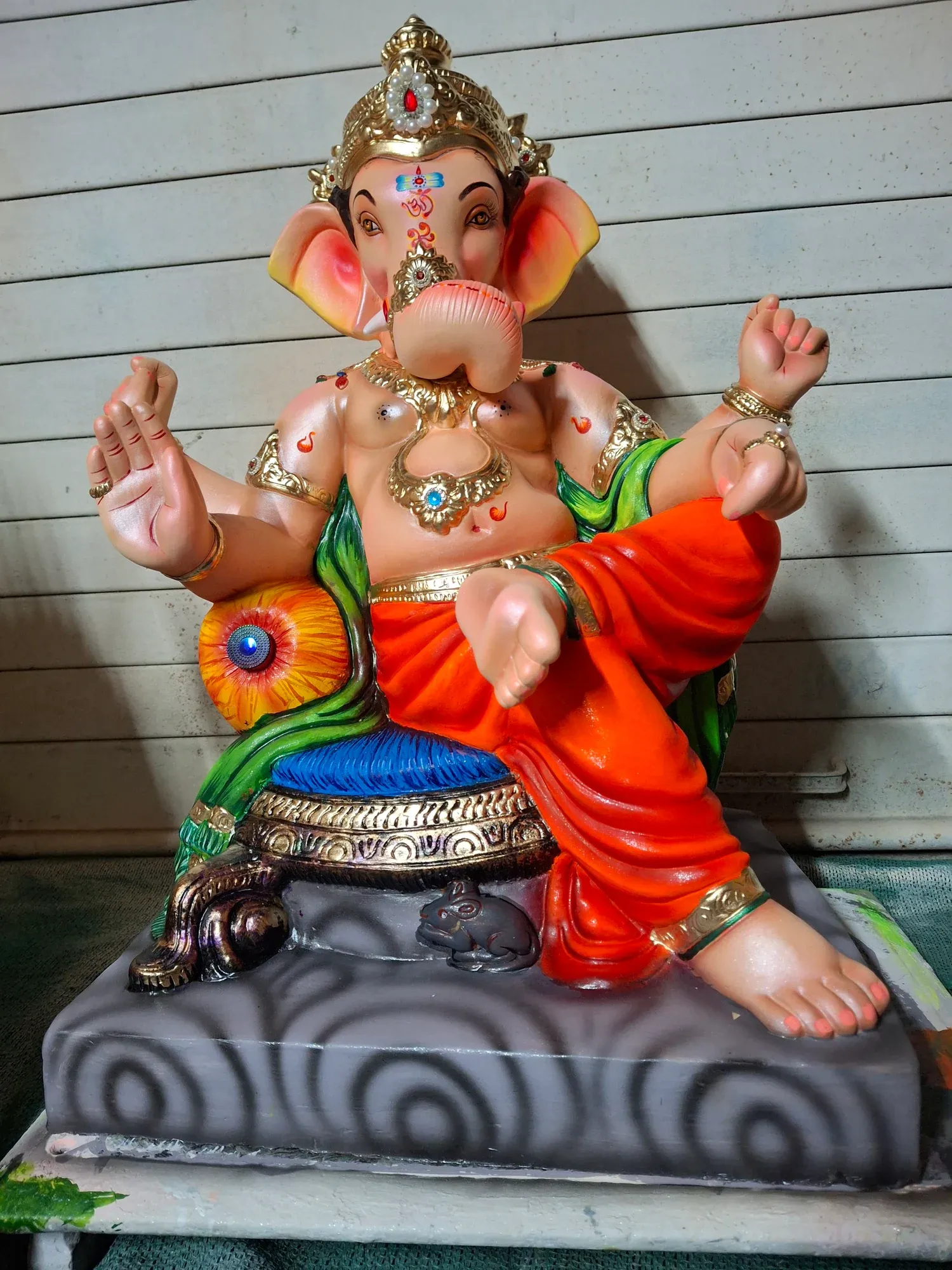 A brightly painted Ganesh idol finished and ready for packing