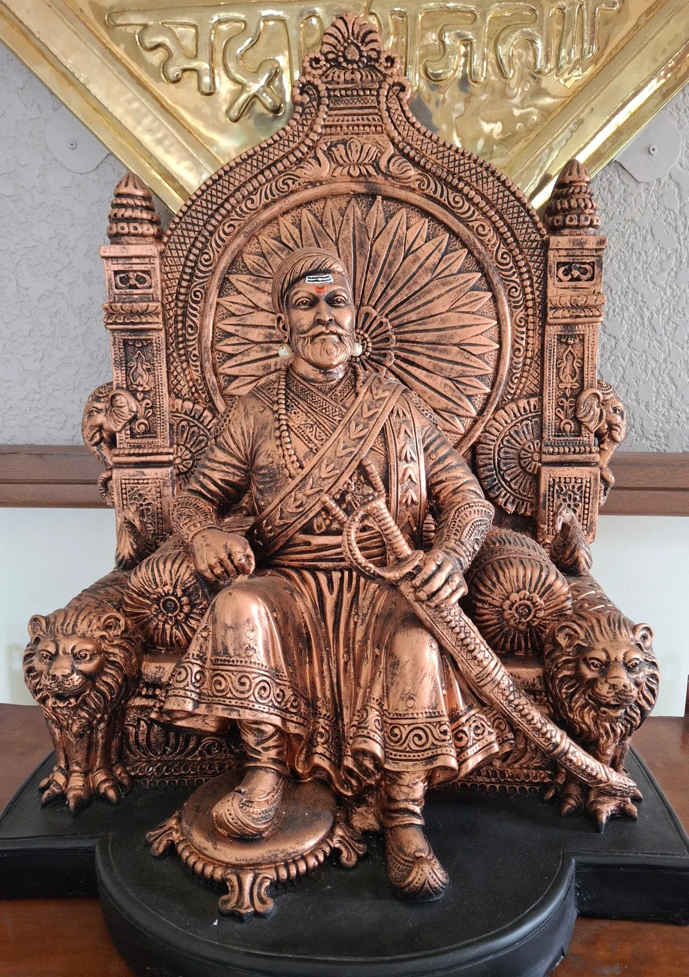 A bronze-finish seated statue of Chhatrapati Shivaji Maharaj