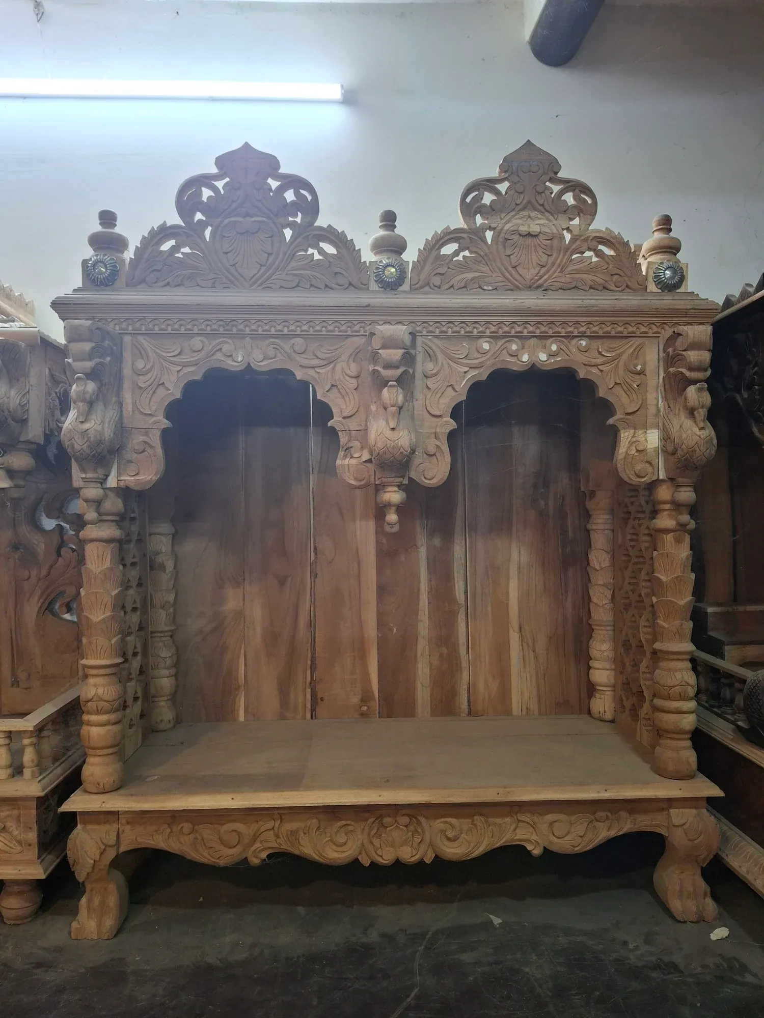 An intricately carved teak wood temple shrine