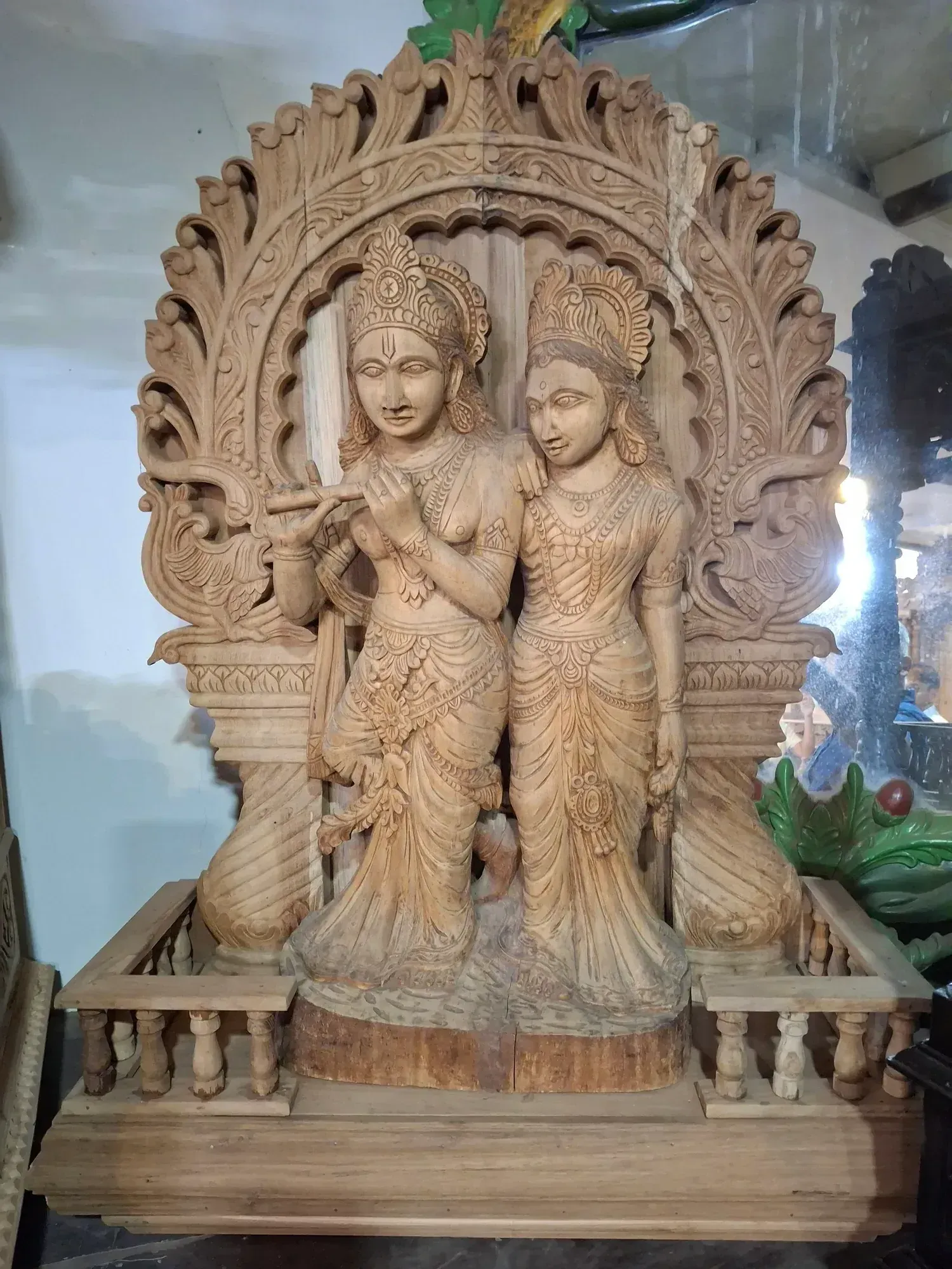 A deep-relief carved wooden murti panel